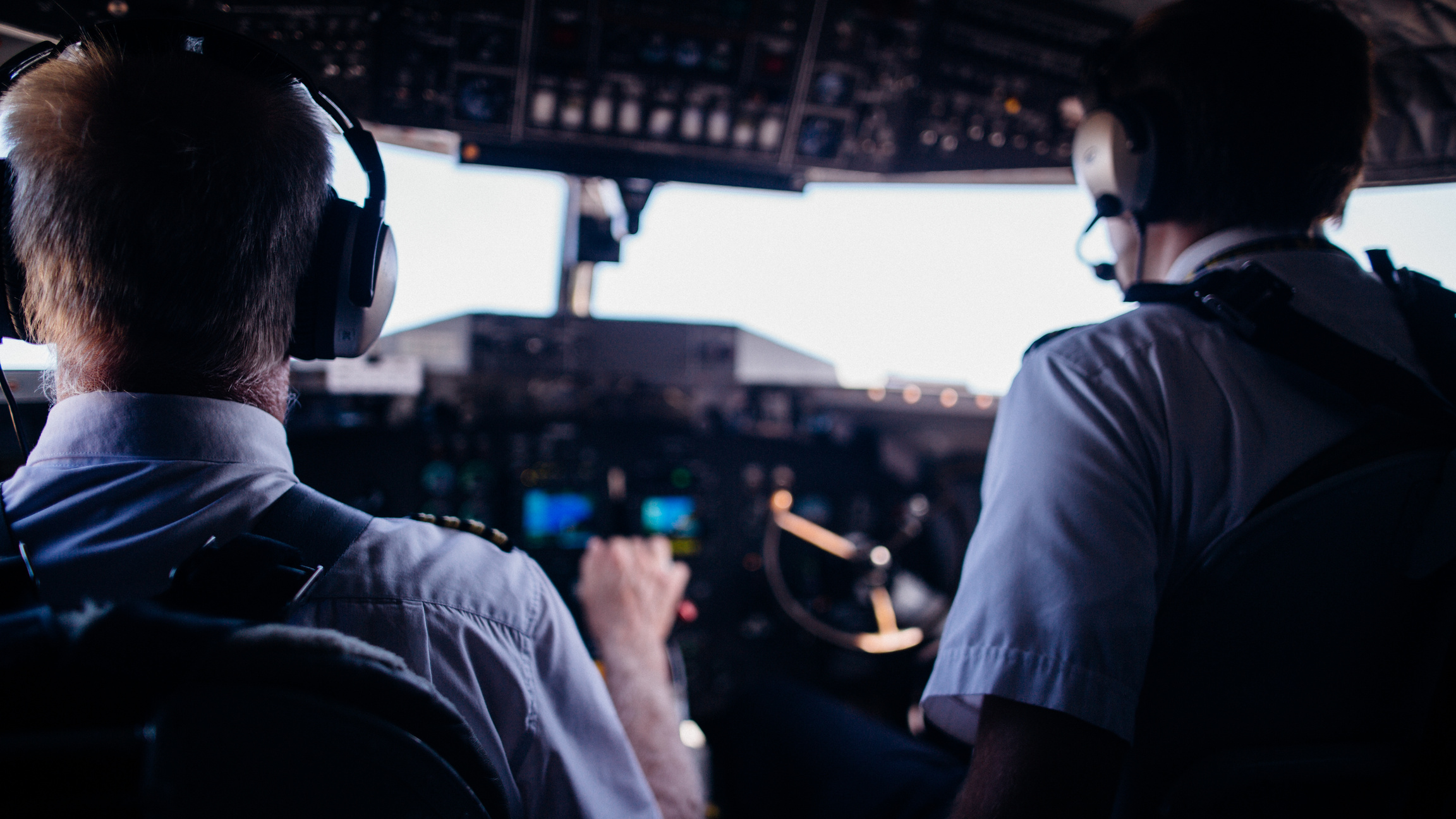 Pilots operating airplane in cockpit during flight